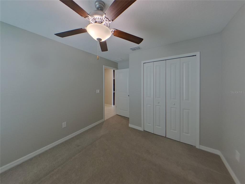 Undisclosed Address Apollo Beach, FL 33572 - Photo 9 of 15 an empty room with a chandelier fan and closet area