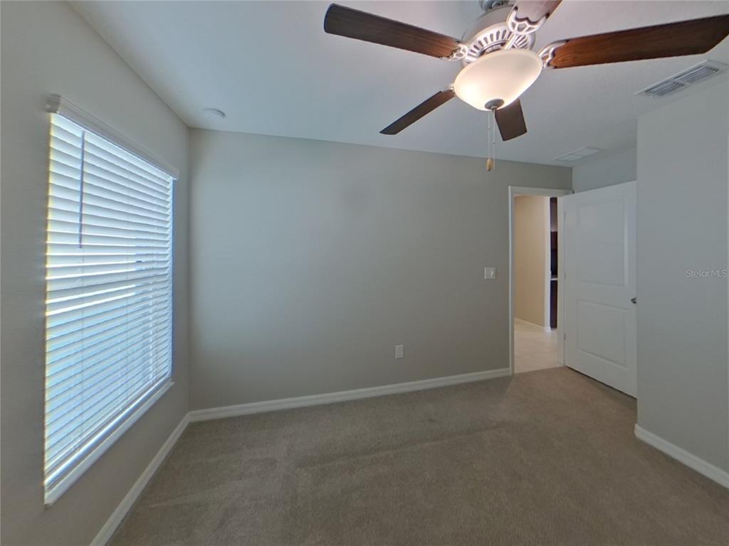 Undisclosed Address Apollo Beach, FL 33572 - Photo 10 of 15 en empty room with windows and fan