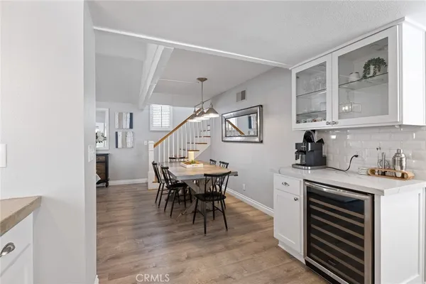 a view of a dining room with furniture and a chandelier