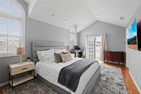 a bedroom with bed and wooden floor