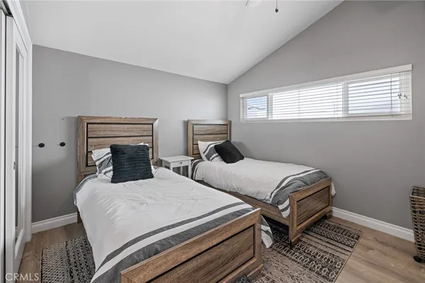 a bedroom with two beds and a window