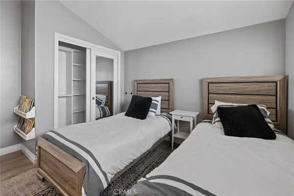 a bedroom with two beds and a lamp