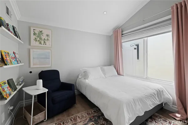 a bedroom with a bed and a chair in it