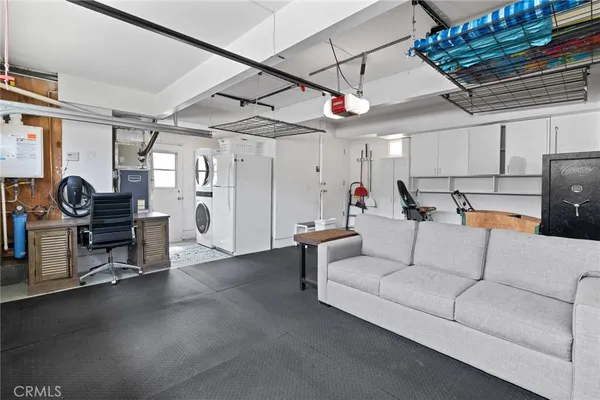 a living room with furniture and a piano