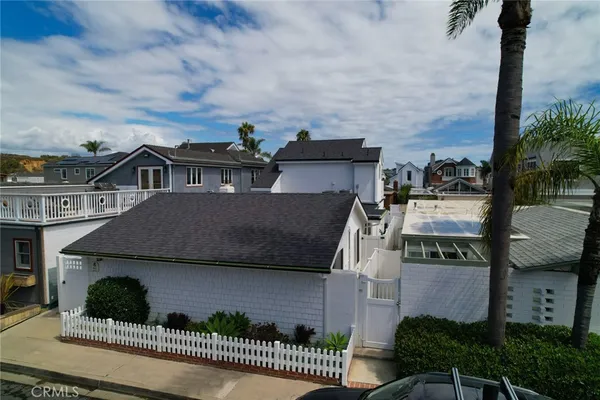 an aerial view of a house with a yard and potted plants