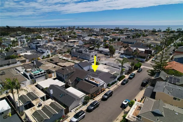 an aerial view of a residential building with parking