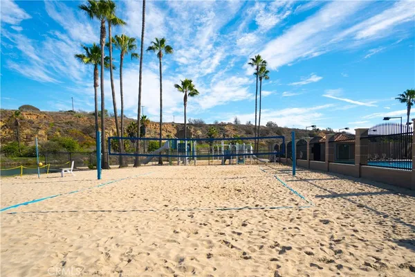 a view of a lake with table and chairs potted plants and lake view