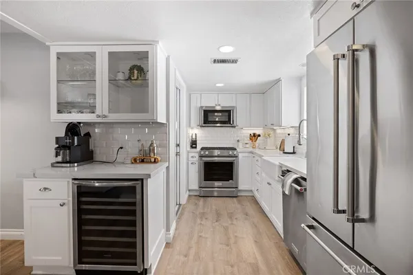 a kitchen with a stove a refrigerator and a sink