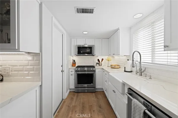 a kitchen with a sink appliances and cabinets