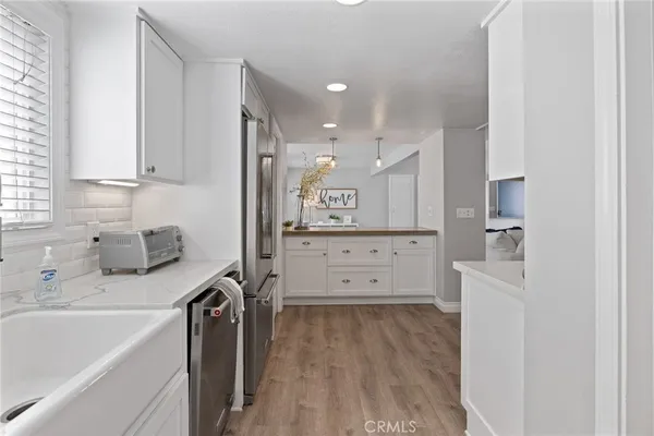 a kitchen with kitchen island white cabinets and counter space