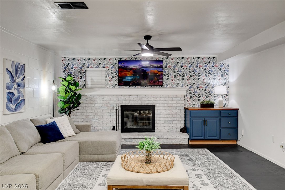 3765 Berkeley Street Logandale, NV 89021 - Photo 6 of 87 This inviting living room features a charming fireplace, perfect for cozy gatherings and relaxation.