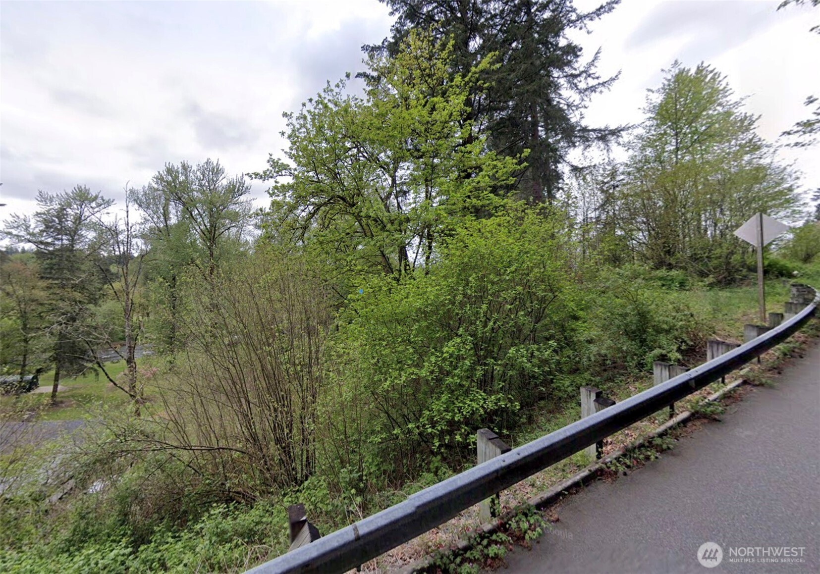 a view of a green field with lots of bushes