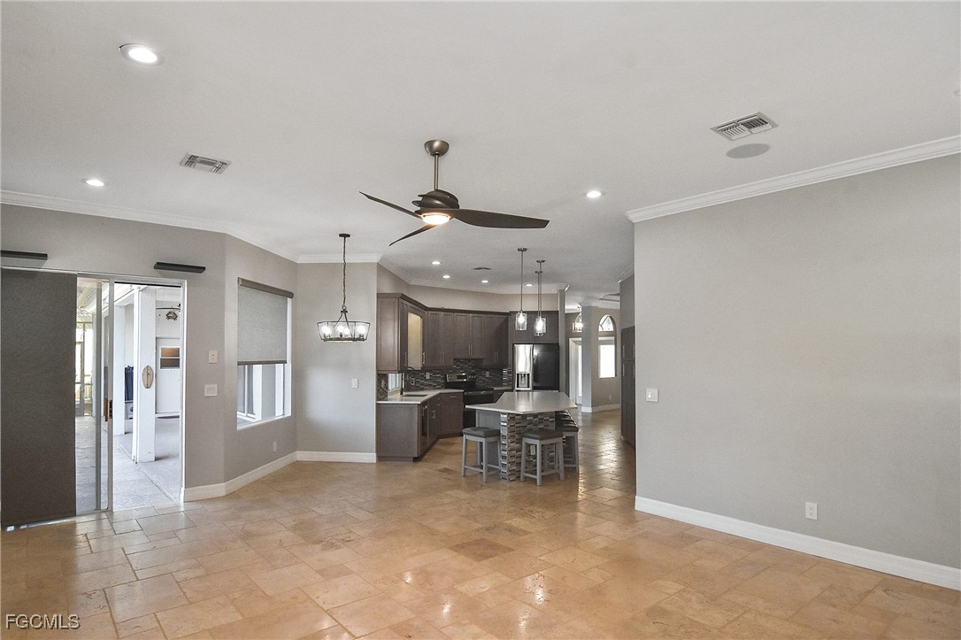 11066 Seminole Palm Way Fort Myers, FL 33966 - Photo 16 of 46 a view of a hallway with furniture and a chandelier