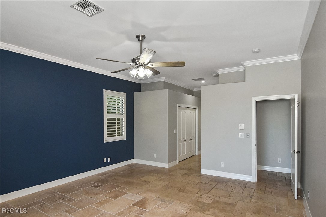 11066 Seminole Palm Way Fort Myers, FL 33966 - Photo 23 of 46 a view of an empty room with a chandelier fan