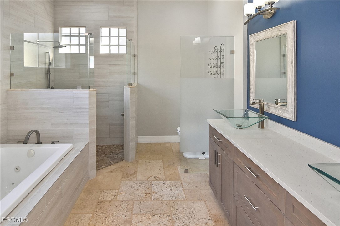 11066 Seminole Palm Way Fort Myers, FL 33966 - Photo 24 of 46 a bathroom with a sink a toilet and shower