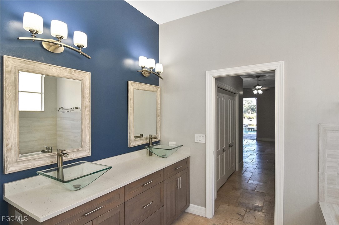 11066 Seminole Palm Way Fort Myers, FL 33966 - Photo 25 of 46 a bathroom with a sink double vanity and a mirror