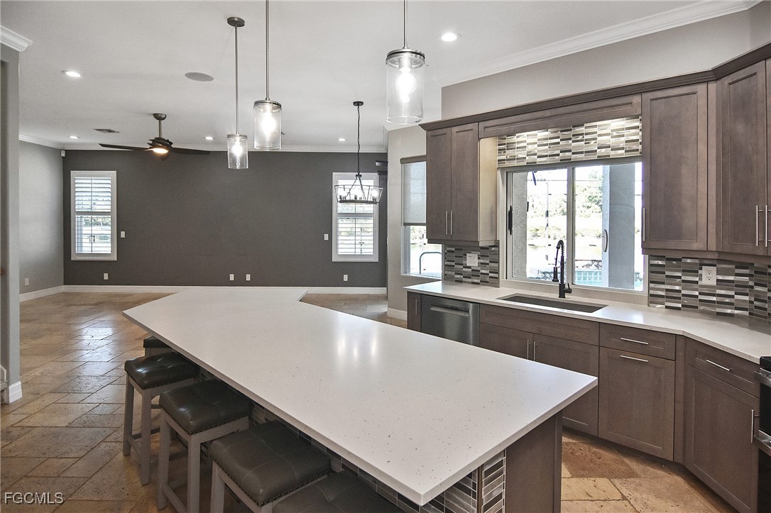 11066 Seminole Palm Way Fort Myers, FL 33966 - Photo 3 of 46 a large kitchen with kitchen island a large island in it