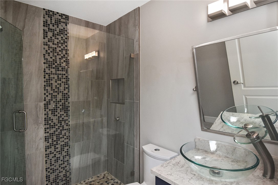 11066 Seminole Palm Way Fort Myers, FL 33966 - Photo 38 of 46 a bathroom with a sink toilet and shower