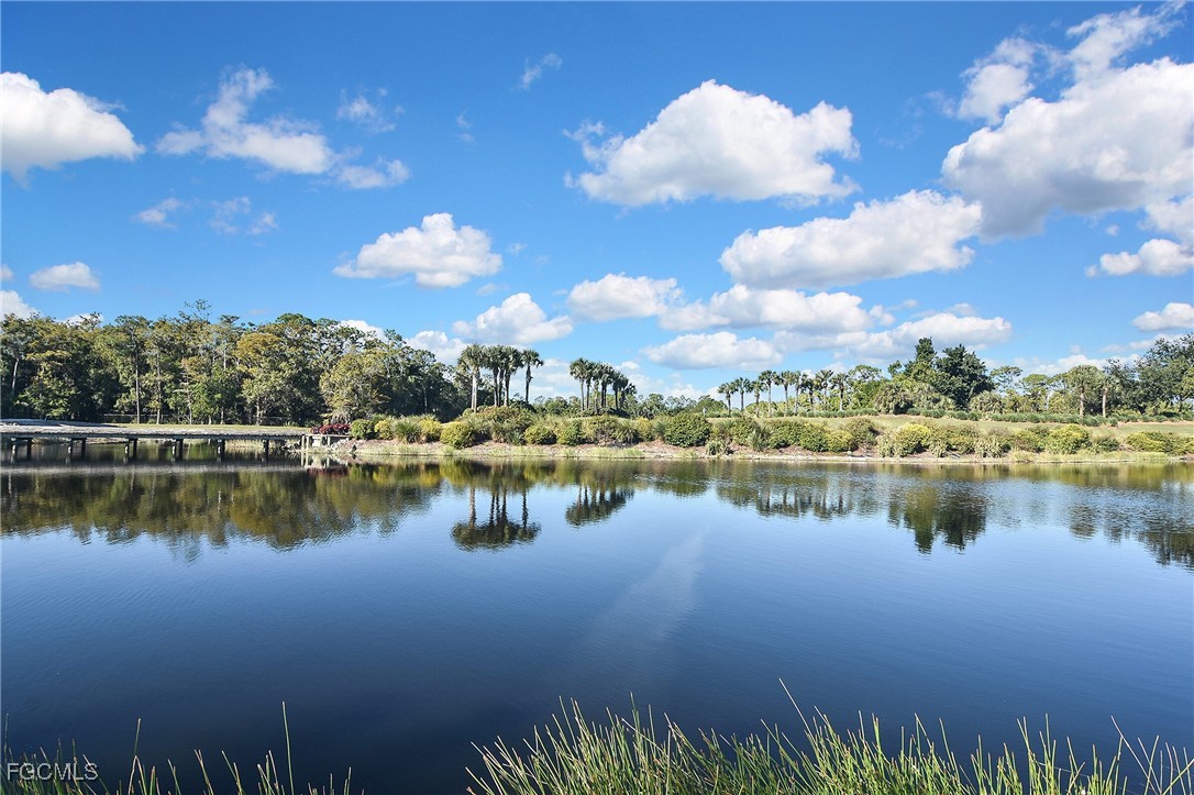 11066 Seminole Palm Way Fort Myers, FL 33966 - Photo 43 of 46 a view of a lake with a house in the background