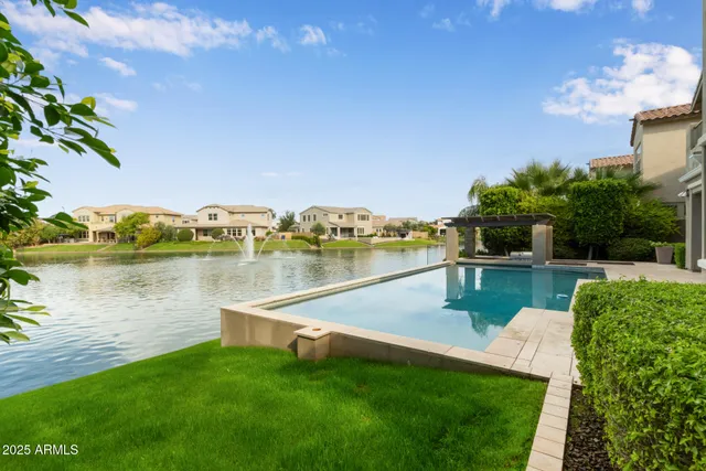 a view of a lake with couches with wooden floor and lake view