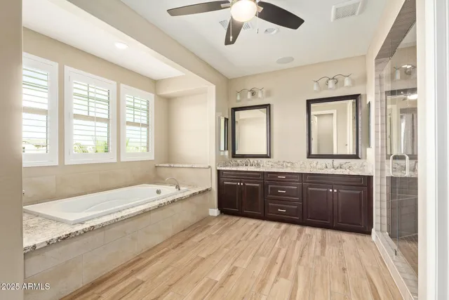 a bathroom with a sink mirror and shower