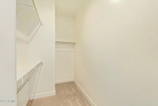 a view of an empty room with a ceiling fan