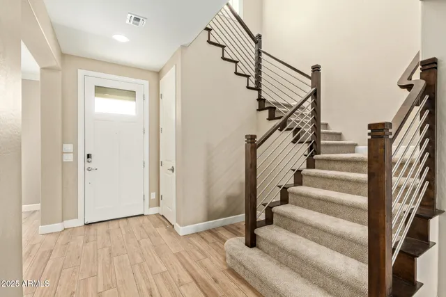 a view of entryway with wooden floor and stairs