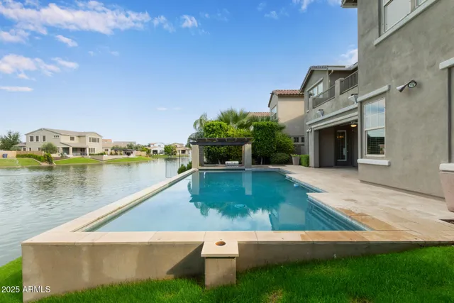 an aerial view of a house with a garden and lake view