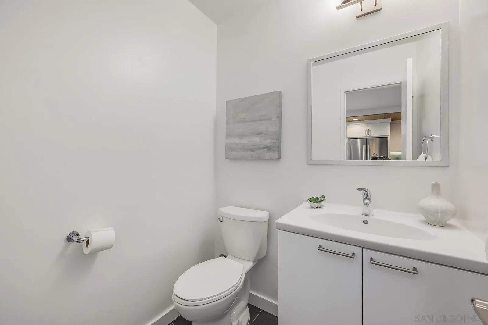 3040 Via De Caballo Encinitas, CA 92024 - Photo 20 of 39 a bathroom with a toilet a sink and mirror
