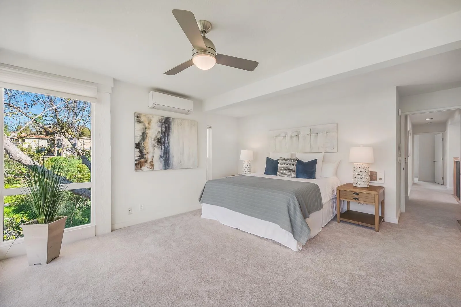 3040 Via De Caballo Encinitas, CA 92024 - Photo 23 of 39 a spacious bedroom with a bed and a large window