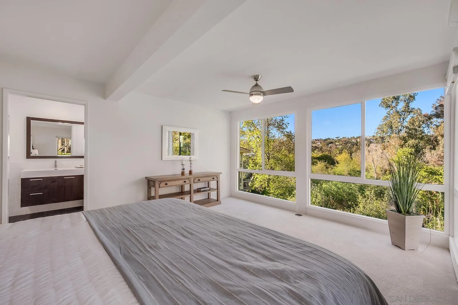 3040 Via De Caballo Encinitas, CA 92024 - Photo 25 of 39 a bedroom with a bed and a large window