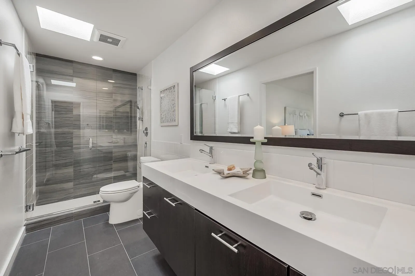3040 Via De Caballo Encinitas, CA 92024 - Photo 26 of 39 a bathroom with a double vanity sink toilet and shower