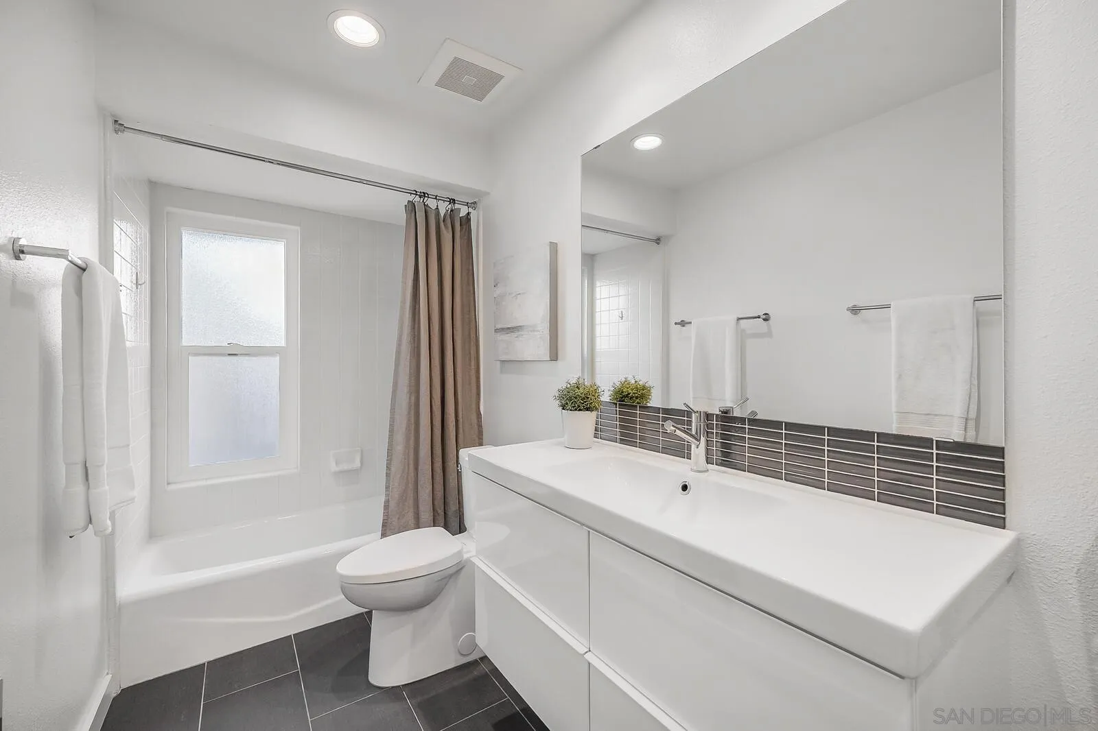 3040 Via De Caballo Encinitas, CA 92024 - Photo 31 of 39 a bathroom with a sink a toilet and shower