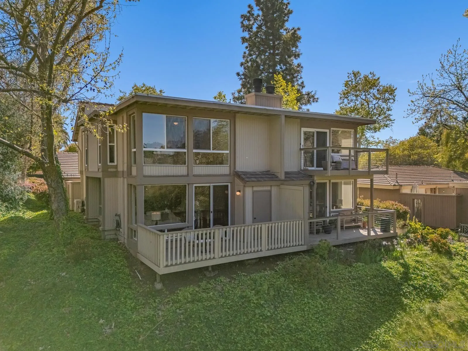 3040 Via De Caballo Encinitas, CA 92024 - Photo 33 of 39 a view of a house with a yard and deck