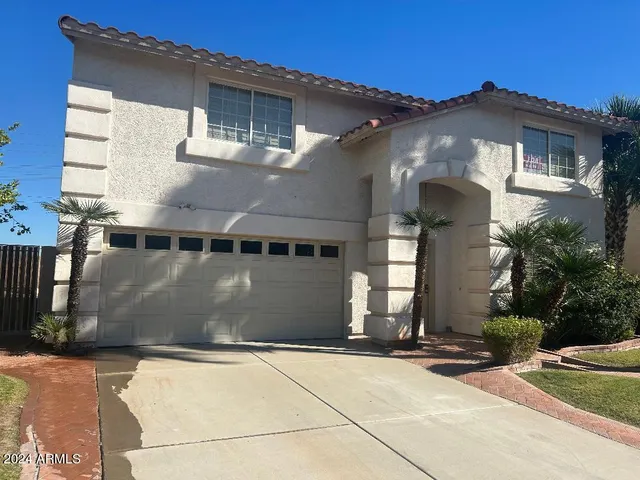 a front view of a house with garage