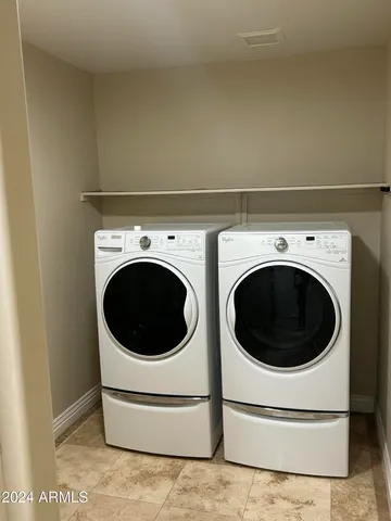a view of patio with table and chairs