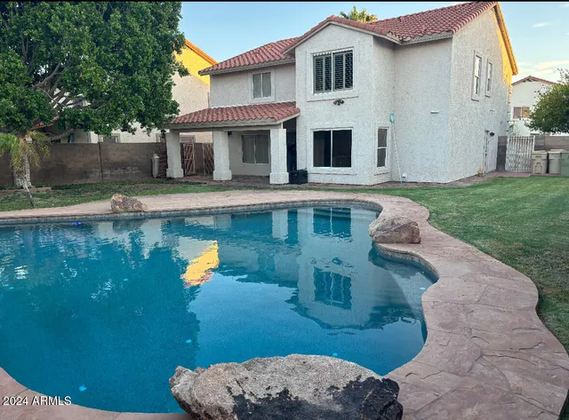 a view of a yard with swimming pool