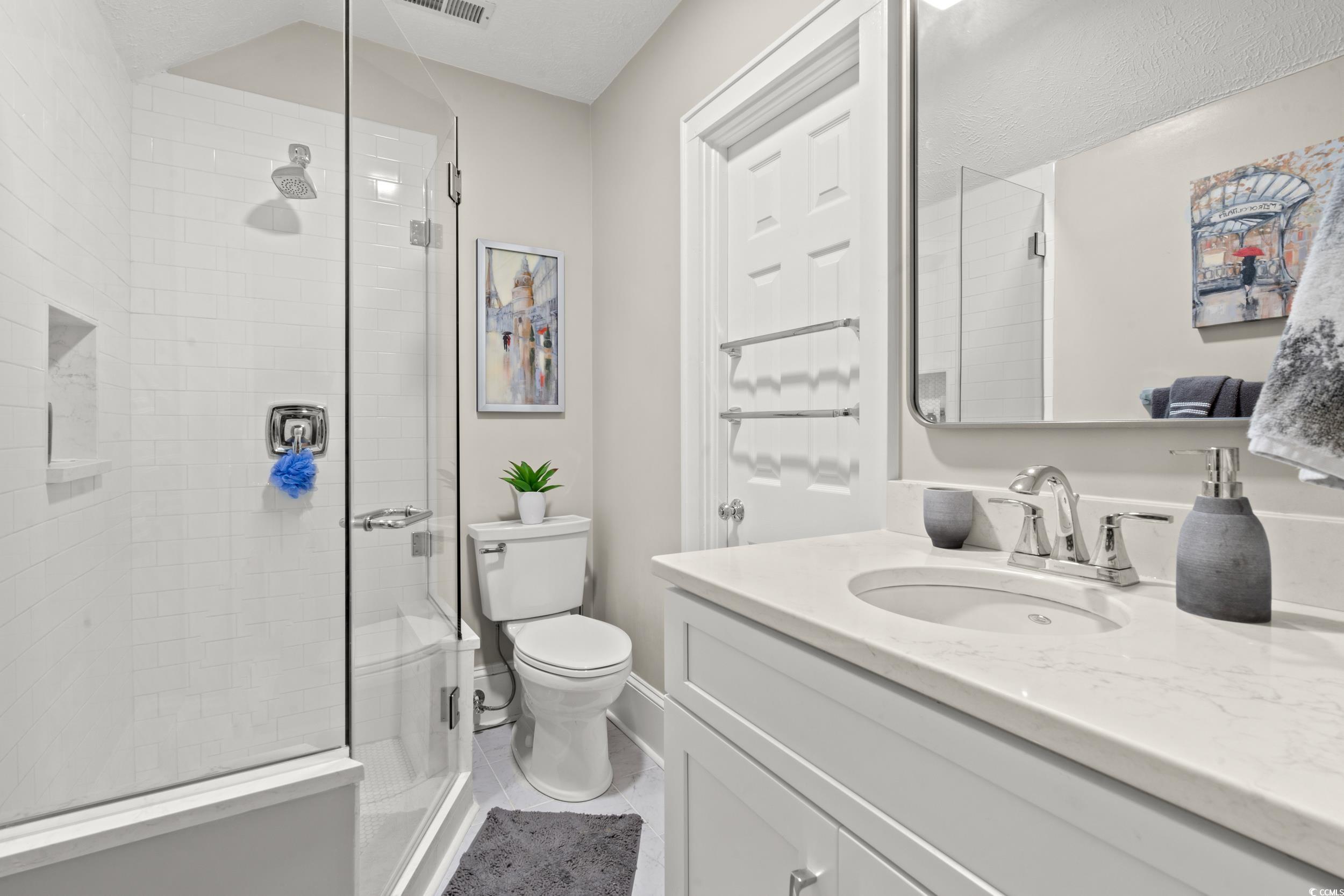 700 Lakeside Drive Conway, SC 29526 - Photo 27 of 40 Full bathroom featuring vanity, a shower stall, and light tile patterned floors