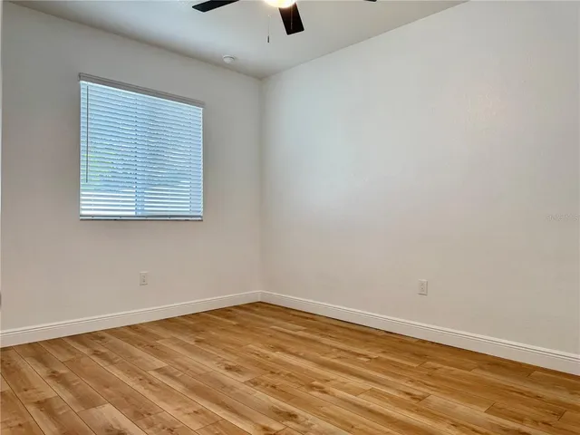 wooden floor in an empty room with a window