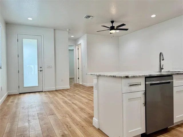 a view of an empty room with a ceiling fan