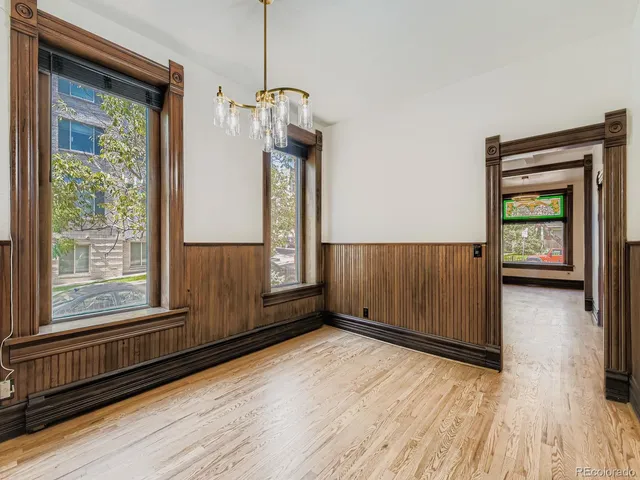 a view of a room with wooden floor and windows