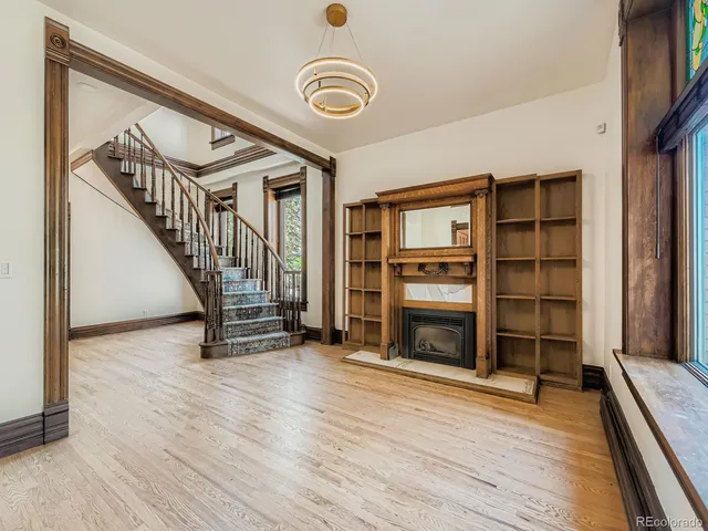 a view of an empty room with a fireplace and a window