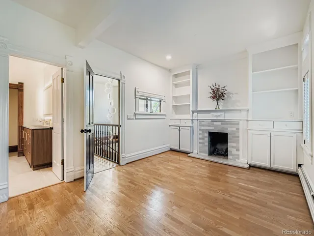 a view of livingroom with an entryway and fireplace
