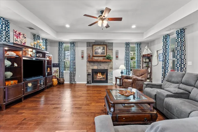 a living room with furniture a flat screen tv and a fireplace