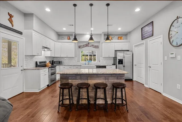 a large kitchen with a table and chairs