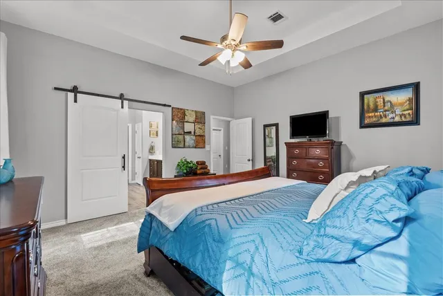 a bedroom with a bed and a television