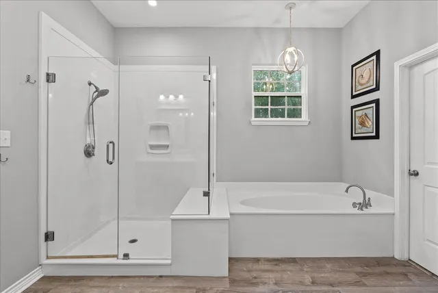 a bathroom with a bathtub and a shower