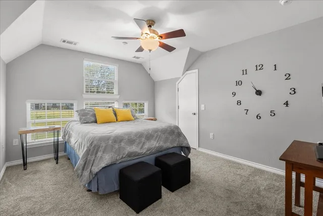 a bedroom with a bed and a table in it