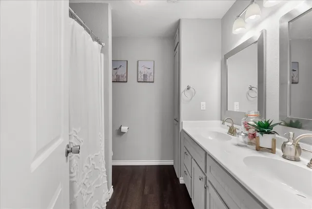 a bathroom with a double vanity sink and mirror