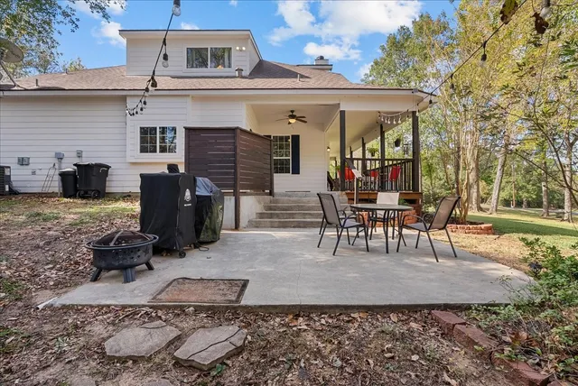a view of a house with backyard porch and furniture